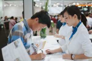 Man signs document at a service counter