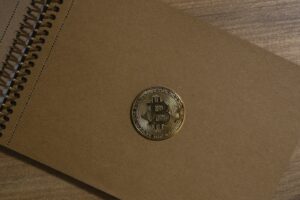 Bitcoin coin on vintage notebook